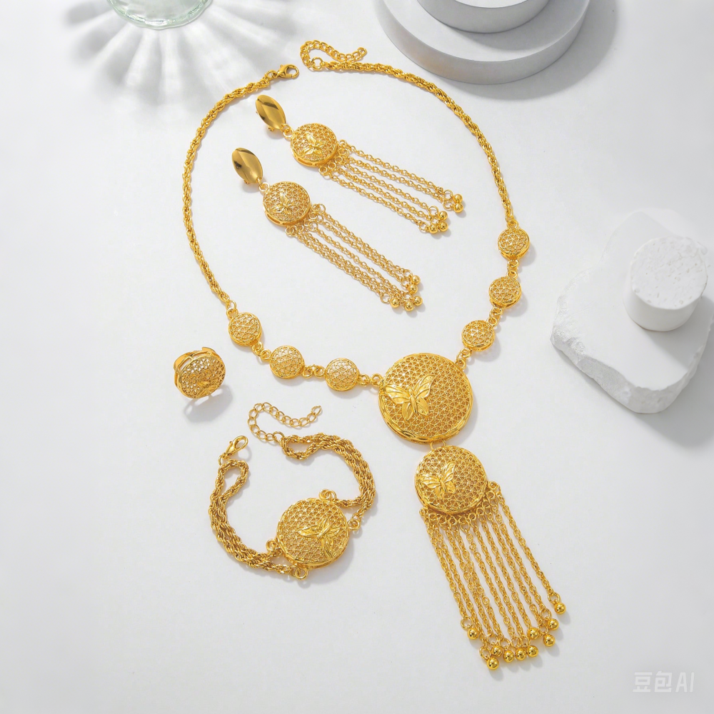 Gold necklace, bracelet, and earrings on a white surface