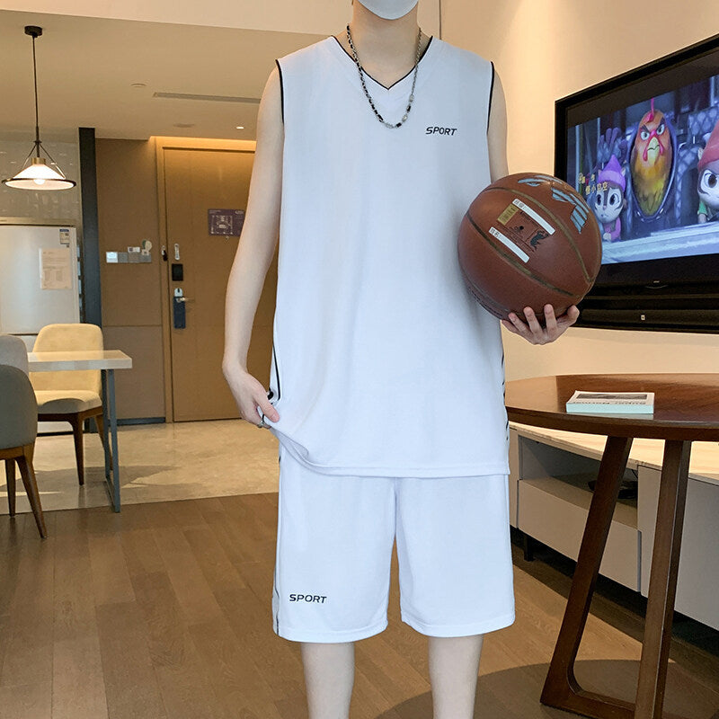 Mannequin wearing a white sports outfit holding a basketball in a room with a TV and furniture.