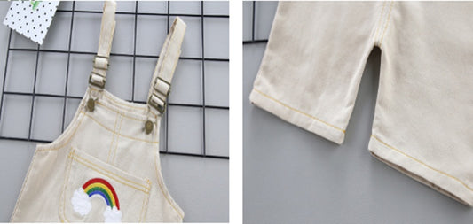 Beige overalls with rainbow design on a grid background