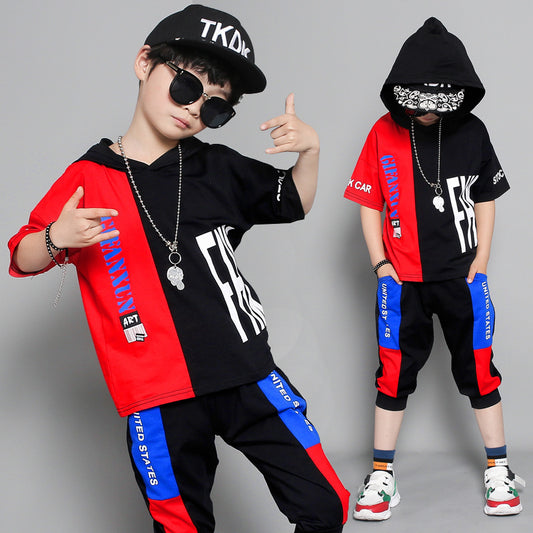 Two children wearing colorful streetwear outfits with prominent branding on a gray background.