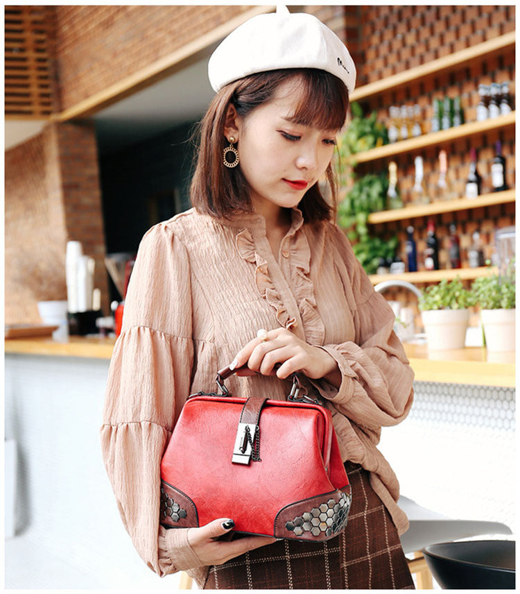 Woman holding a red handbag in an indoor setting with shelves and plants in the background