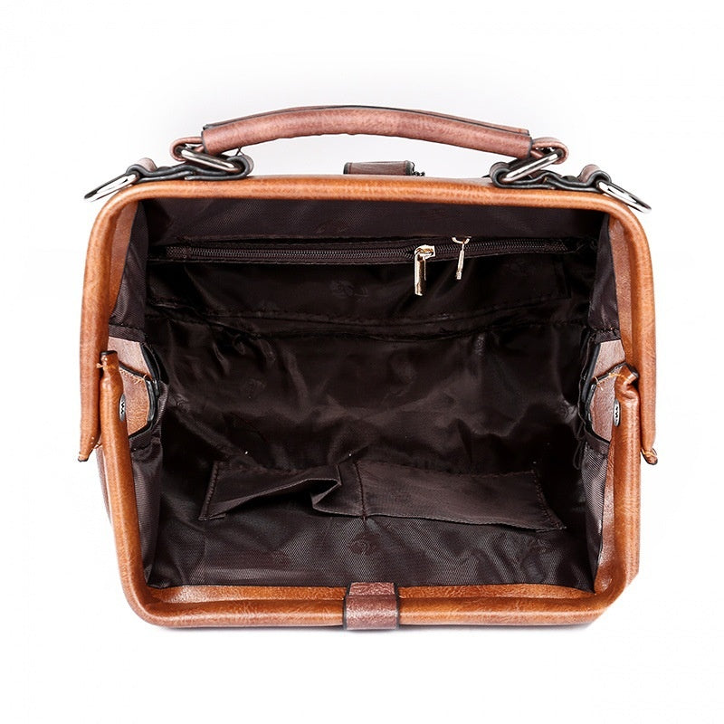 Brown leather briefcase with open interior on a white background