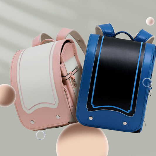 Pink and blue backpacks on a gray background
