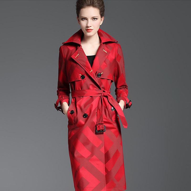 Woman wearing a red trench coat on a gray background by millivan