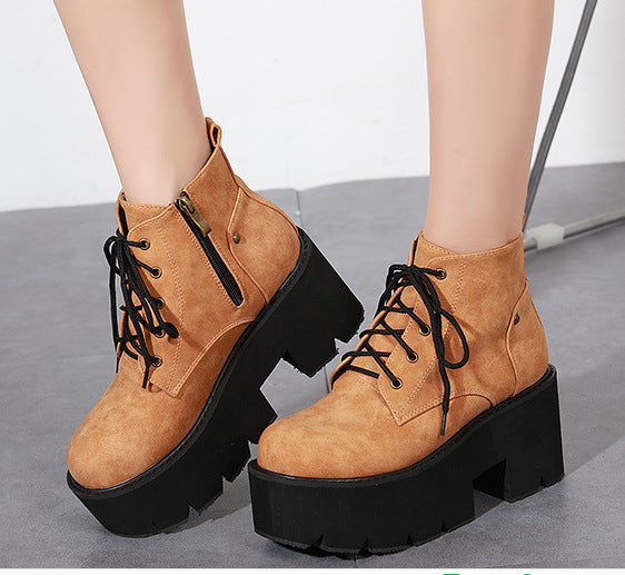 Tan platform boots with black soles on a neutral background