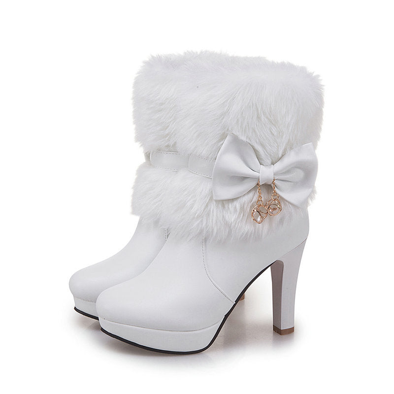 White high-heeled boot with a decorative bow on a white background