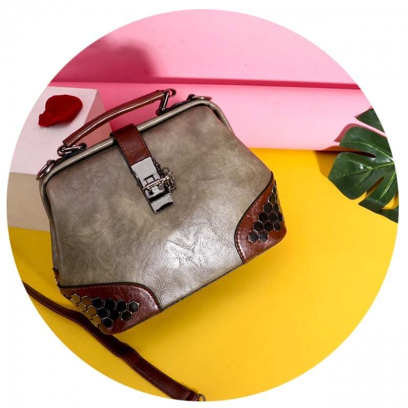 Gray handbag with brown accents on a colorful background