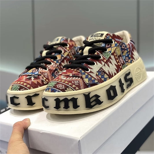 Colorful patterned sneakers with 'Crumbs' branding on a white surface.
