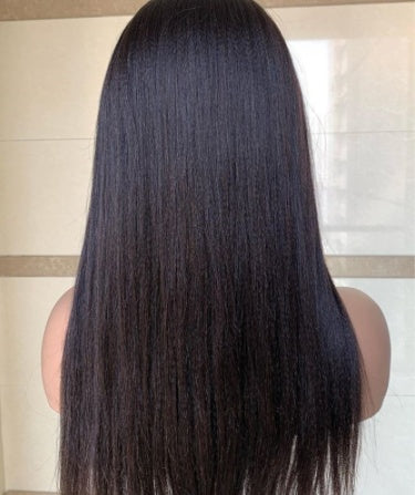 Mannequin head with long, straight black hair on a neutral background