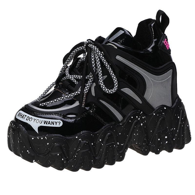 Black and gray sneakers with unique sole design on a white background