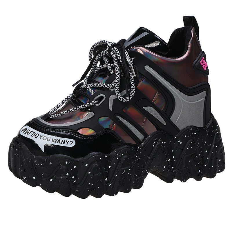 Black sneaker with colorful sole and chain detail on a white background