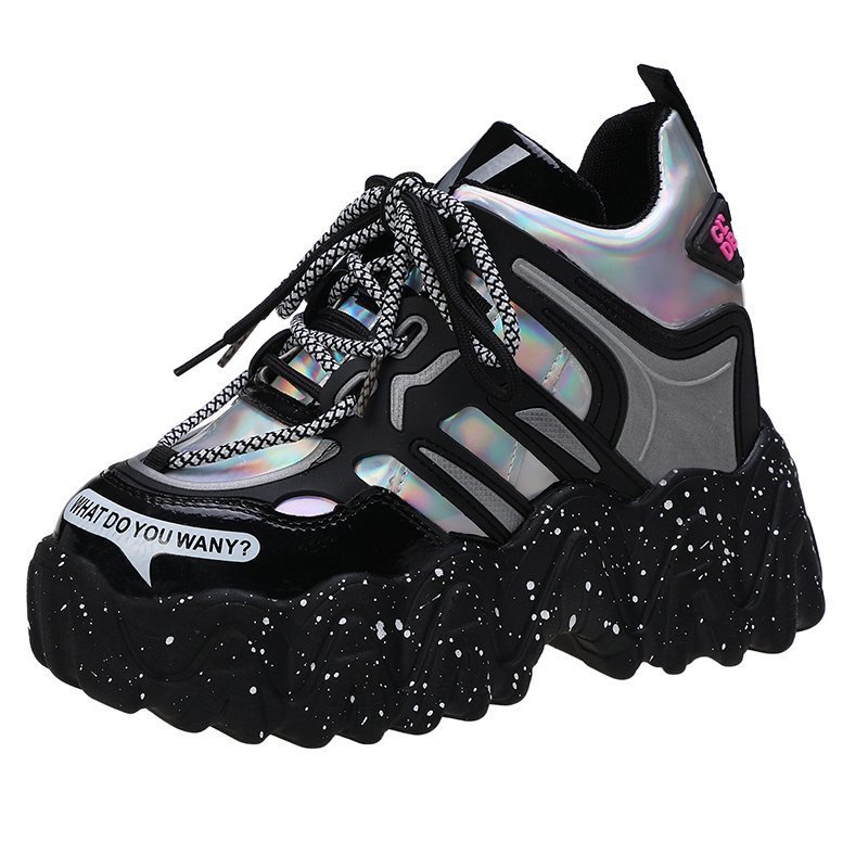 Black and silver sneaker with chain detail on a white background