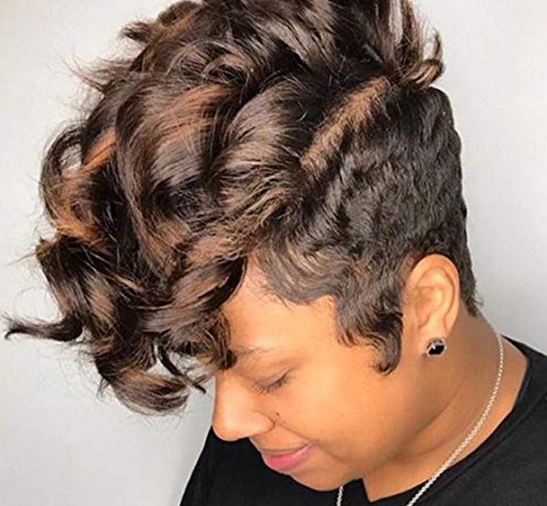 Woman with styled hair looking downwards against a plain background
