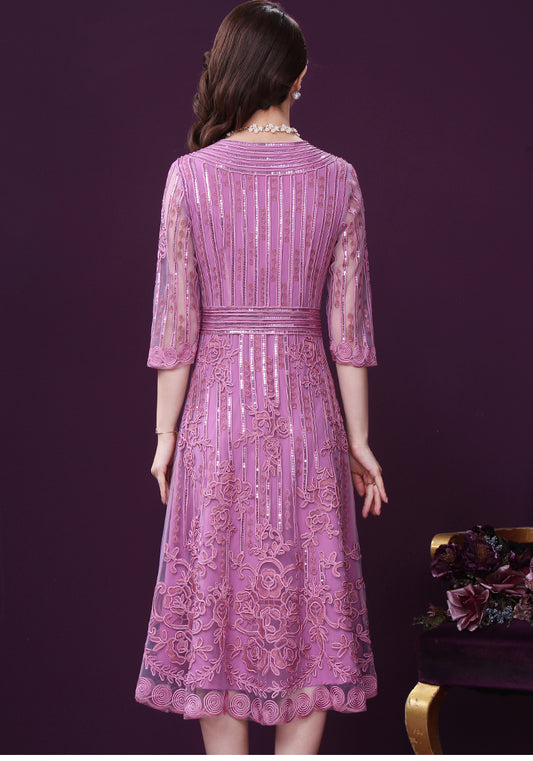 Woman wearing a pink lace dress against a purple background