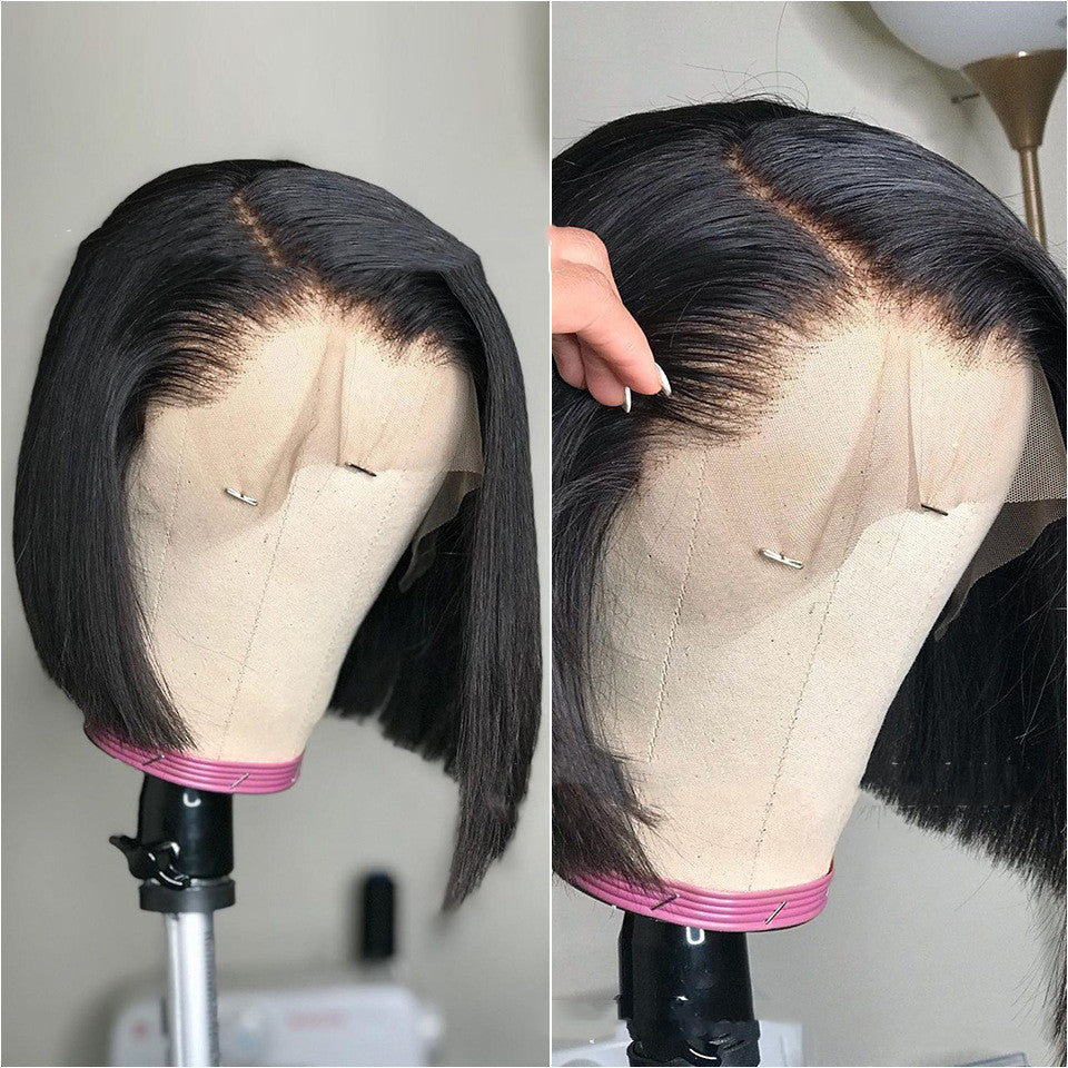 Black lace front wig on a mannequin head with a clear background