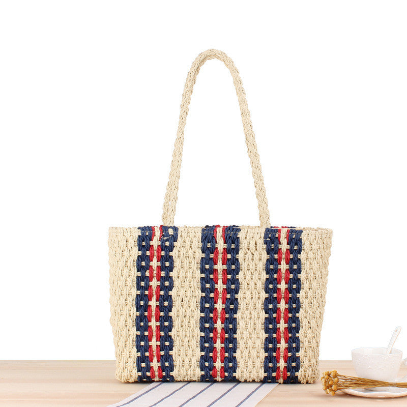 Woven handbag with red and blue pattern on a white background