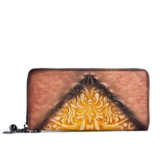Brown leather wallet with intricate yellow tooled design on a white background