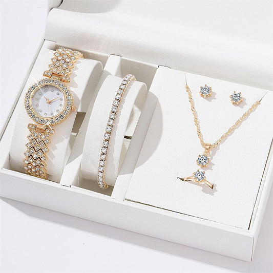 Set of jewelry including a watch, bracelet, necklace, and earrings in a white box.