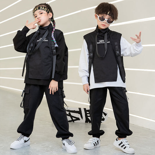 Two children in stylish outfits with black and white clothing, posing against a light background.