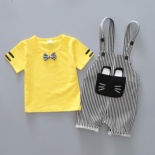 Yellow t-shirt with a bow tie and black and white striped overalls on a gray background