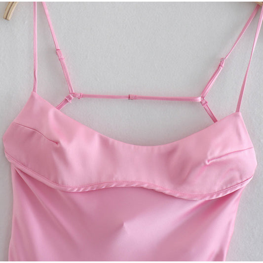 Pink satin camisole with thin straps on a light gray background by millivan