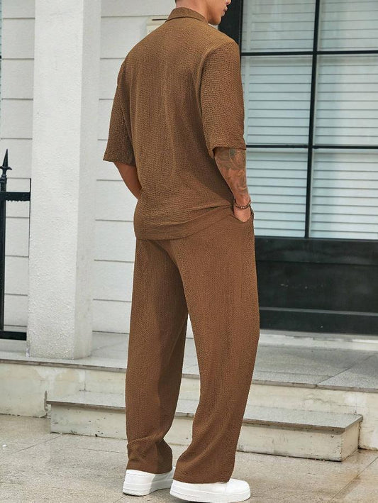 Man wearing a brown outfit standing on a street.