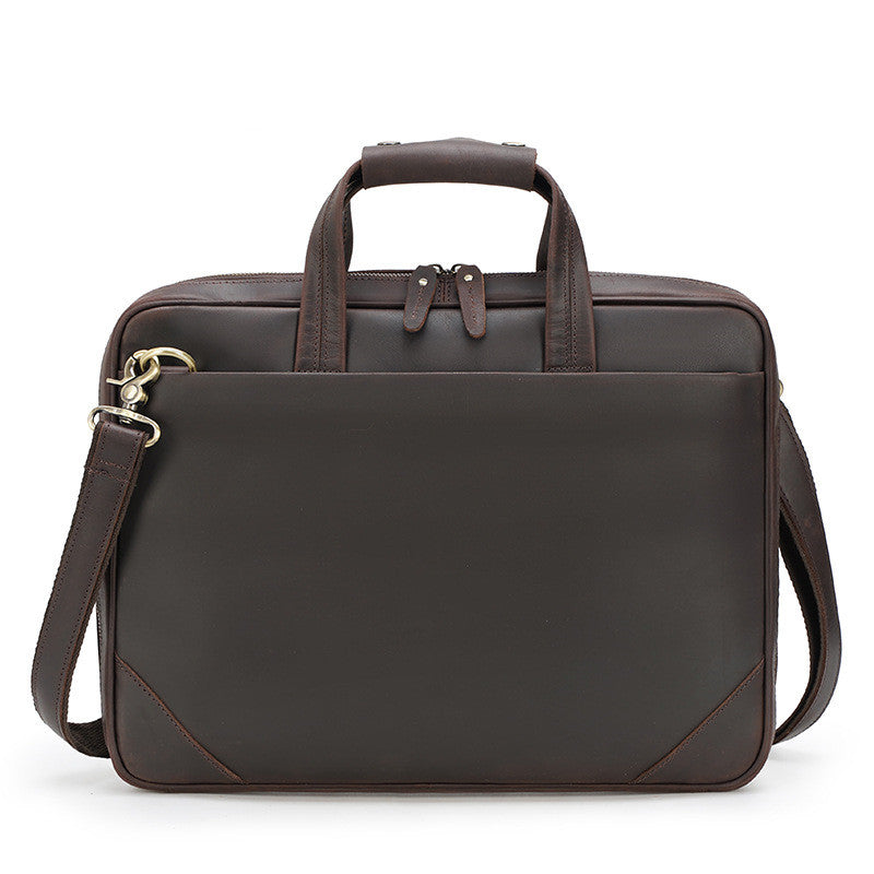 Brown leather briefcase with shoulder strap on a white background