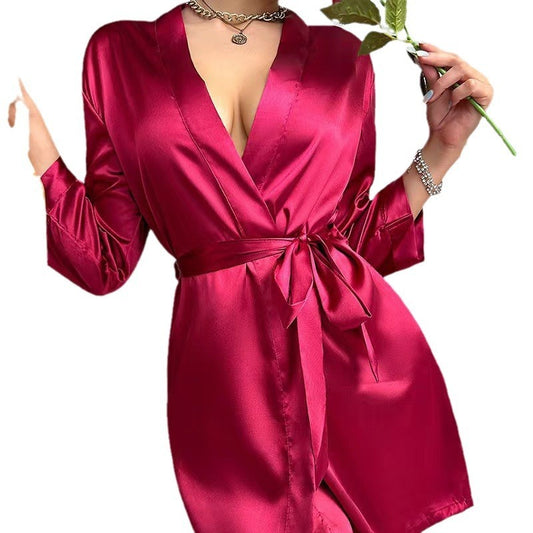 Pink satin robe worn by a person on a white background