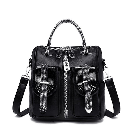 Black backpack with silver embellishments on a white background