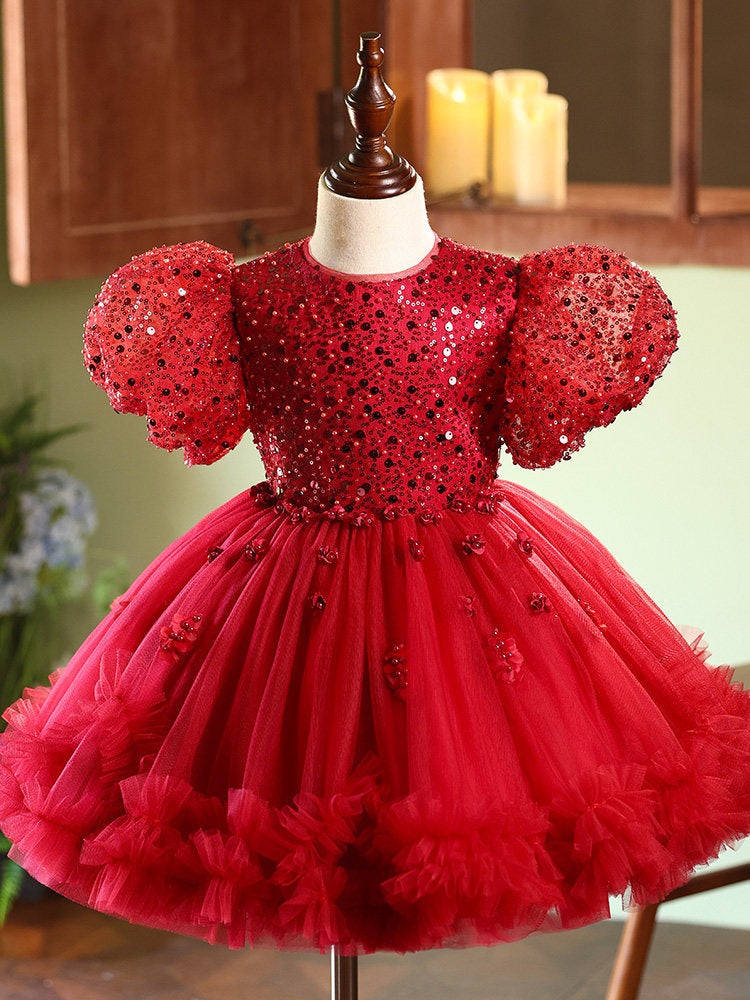 Red sequin dress on a mannequin with a blurred background