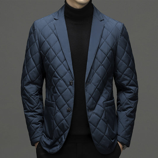 Quilted blue jacket worn by a person on a gray background