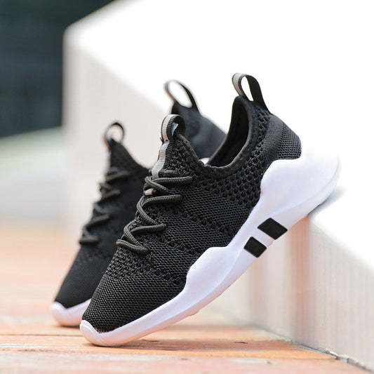 Black and white sneakers on a wooden surface with a blurred background
