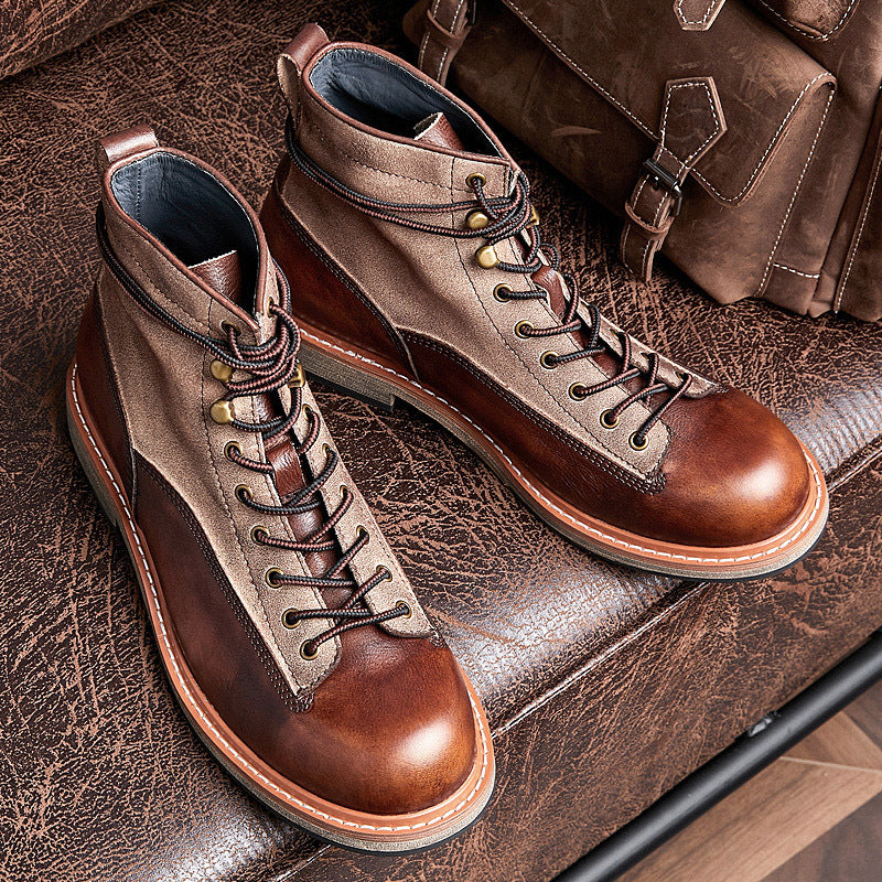 Pair of brown leather boots on a textured surface with a brown bag in the background.
