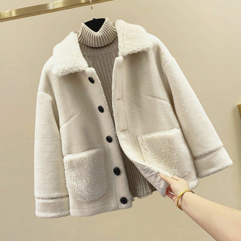 Beige sherpa jacket with black buttons on a beige background