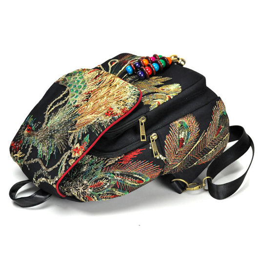 Embroidered backpack with peacock design on a white background