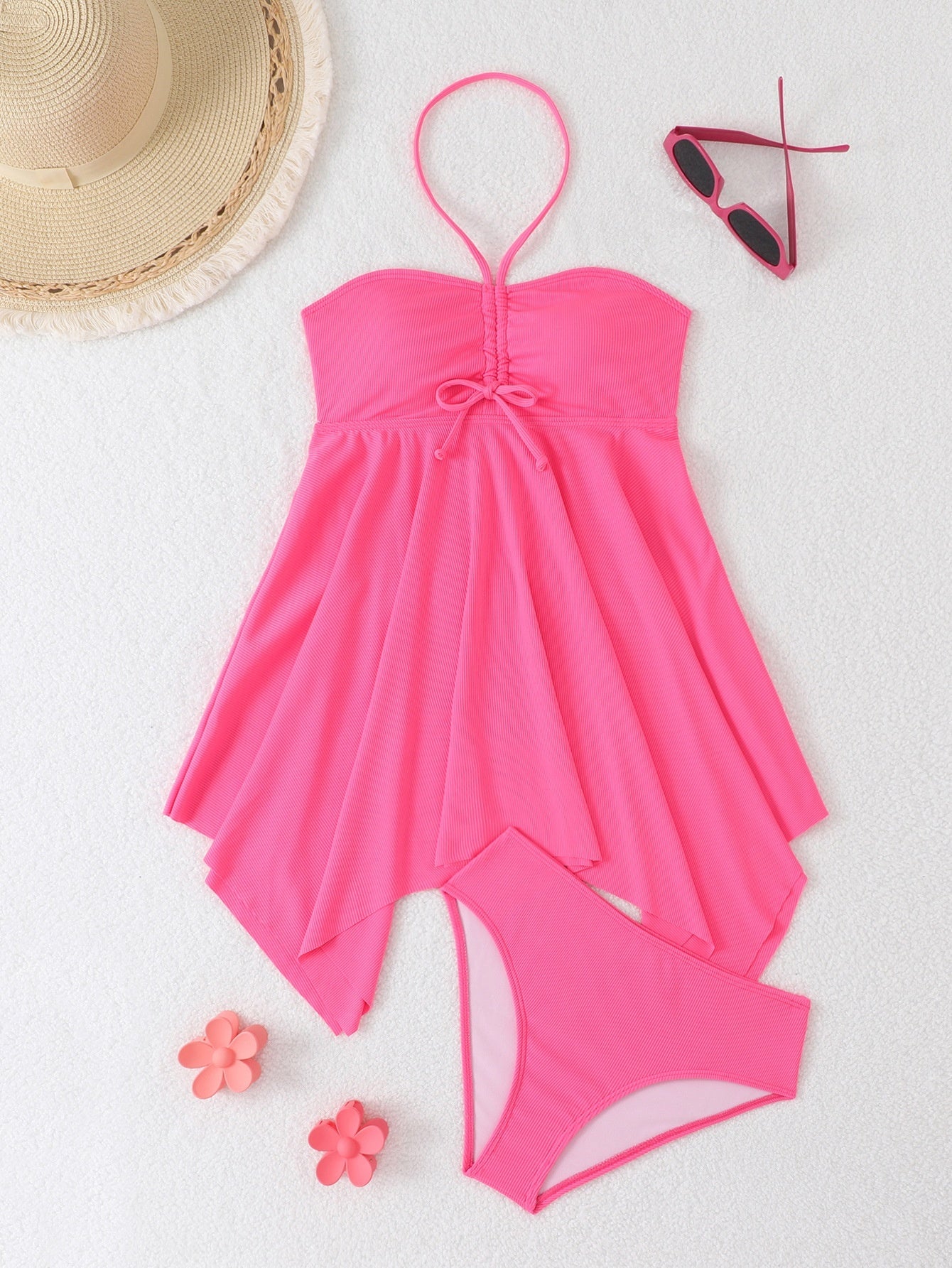 Pink swimsuit with a hat, sunglasses, and flowers on a white background