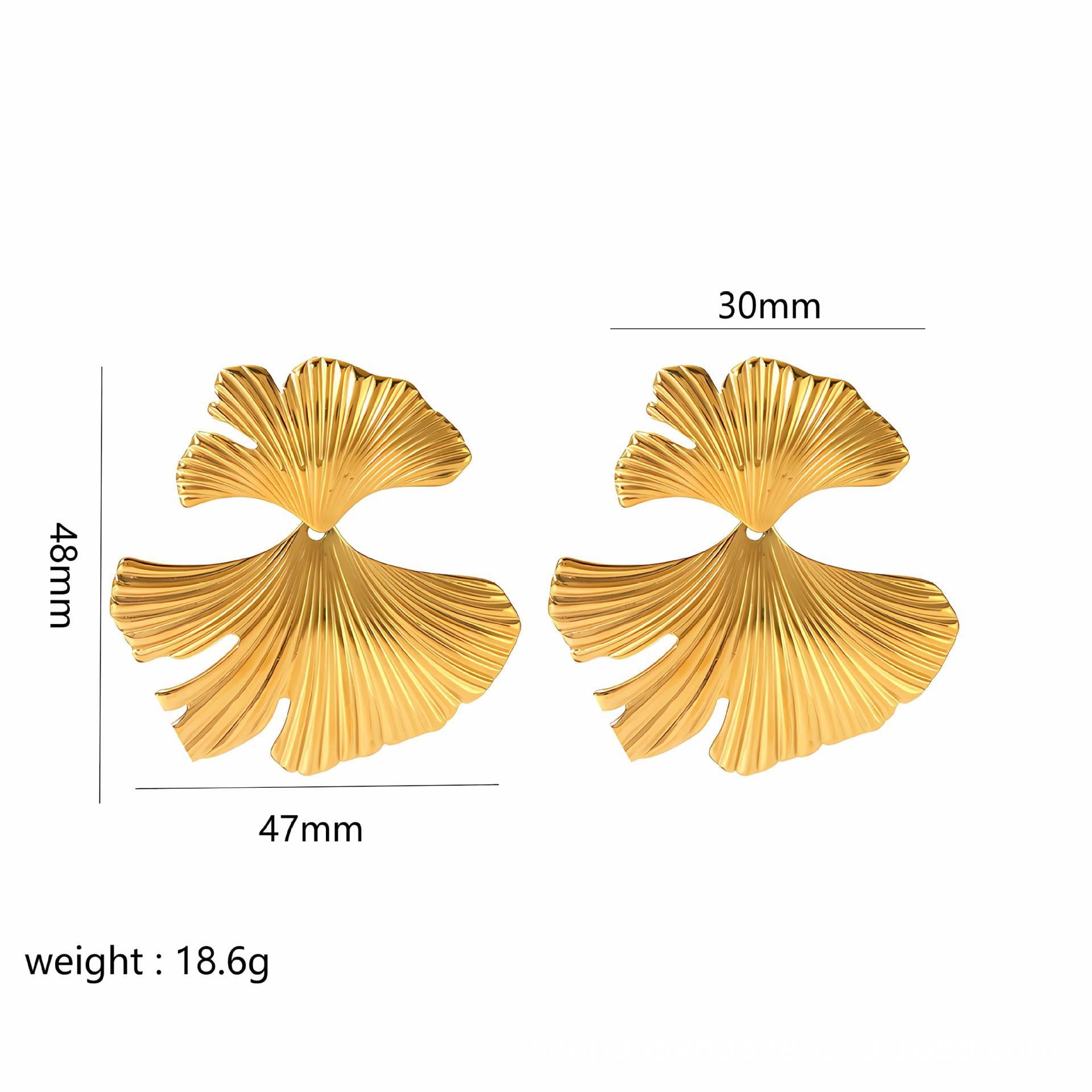 Gold leaf-shaped earrings with measurements on a white background
