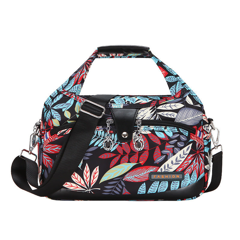 Multicolored floral-patterned handbag on a white background