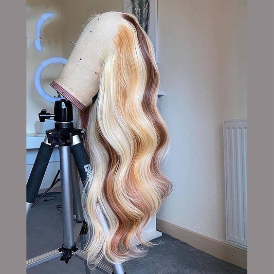 Mannequin head with long, wavy hair on a stand in a room setting.