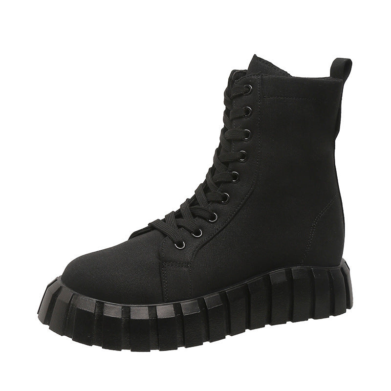 Black high-top boot with thick sole on a white background