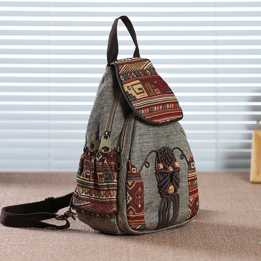 Textured backpack with tribal patterns and designs on a neutral background
