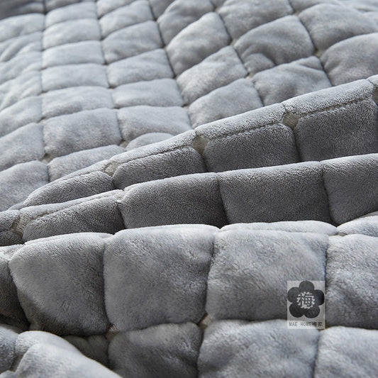 Close-up of a textured gray fabric surface with a brand logo in the corner.
