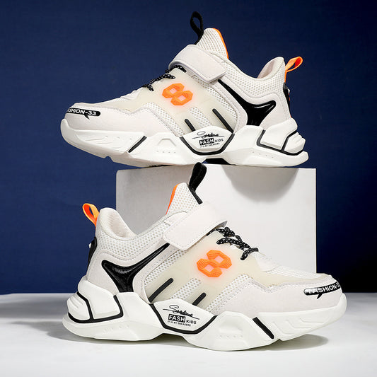 White sneakers with black and orange accents on a white block against a blue background