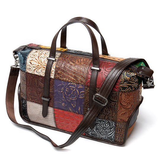 Patchwork handbag with leather straps on a white background