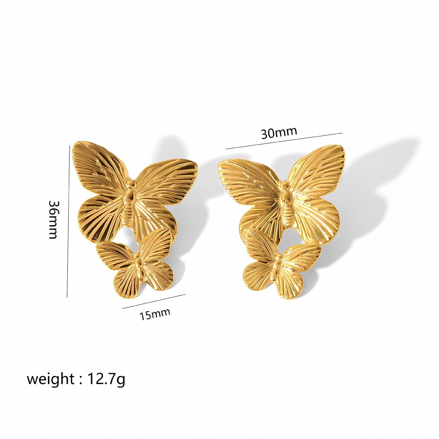 Gold butterfly earrings with measurements on a white background