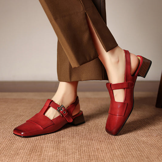 Red shoes with brown pants on a neutral background