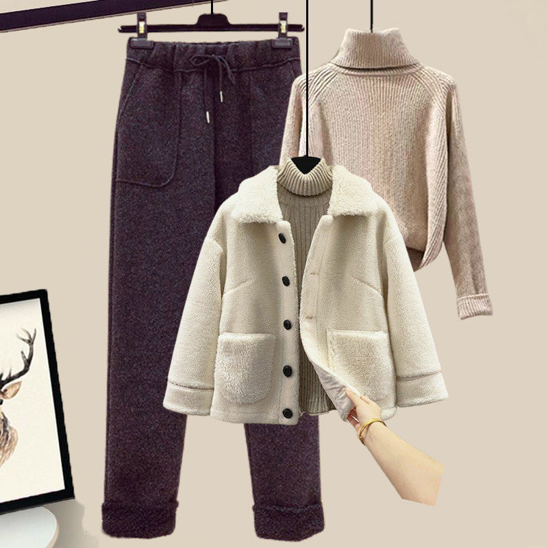 Coat, pants, and sweater displayed on hangers against a neutral background