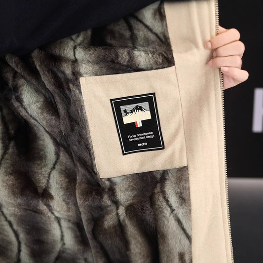 Close-up of a gray textured jacket with a brand label on a black background