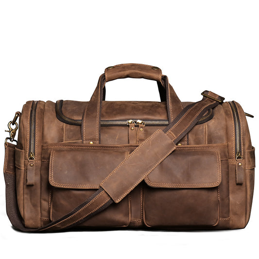 Brown leather duffel bag with shoulder strap on a white background