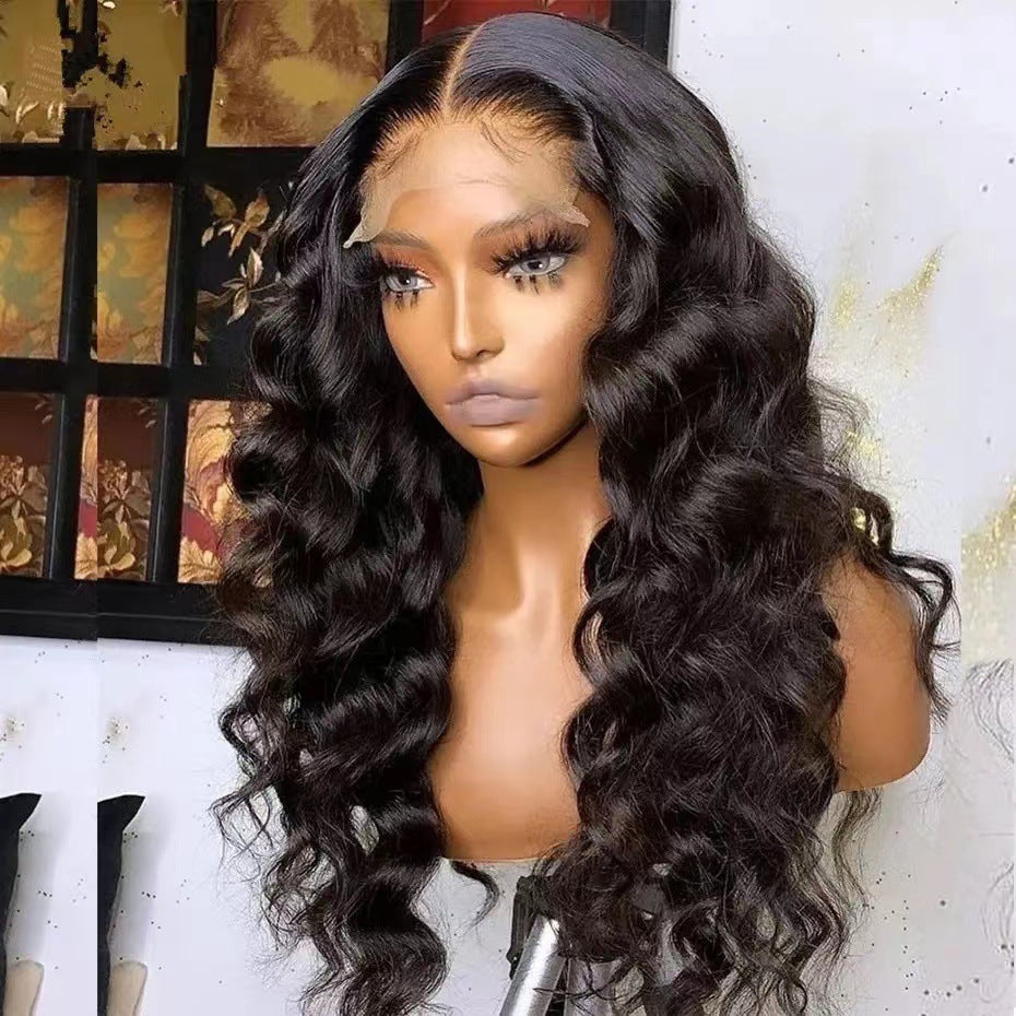 Mannequin head with long, wavy black hair against a decorative wall.